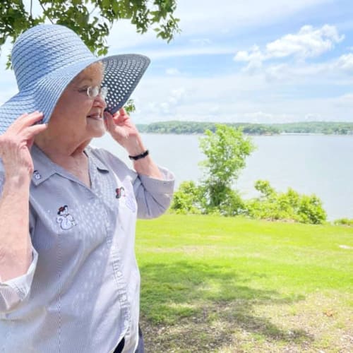 A resident in a hat outside at Oxford Glen Memory Care at Owasso in Owasso, Oklahoma