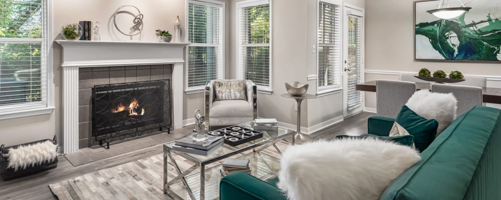 An apartment living room with a fireplace at Renaissance at Galleria in Hoover, Alabama