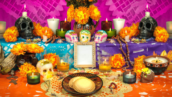 Mexican Day of the Dead altar with sugar skulls and candles
