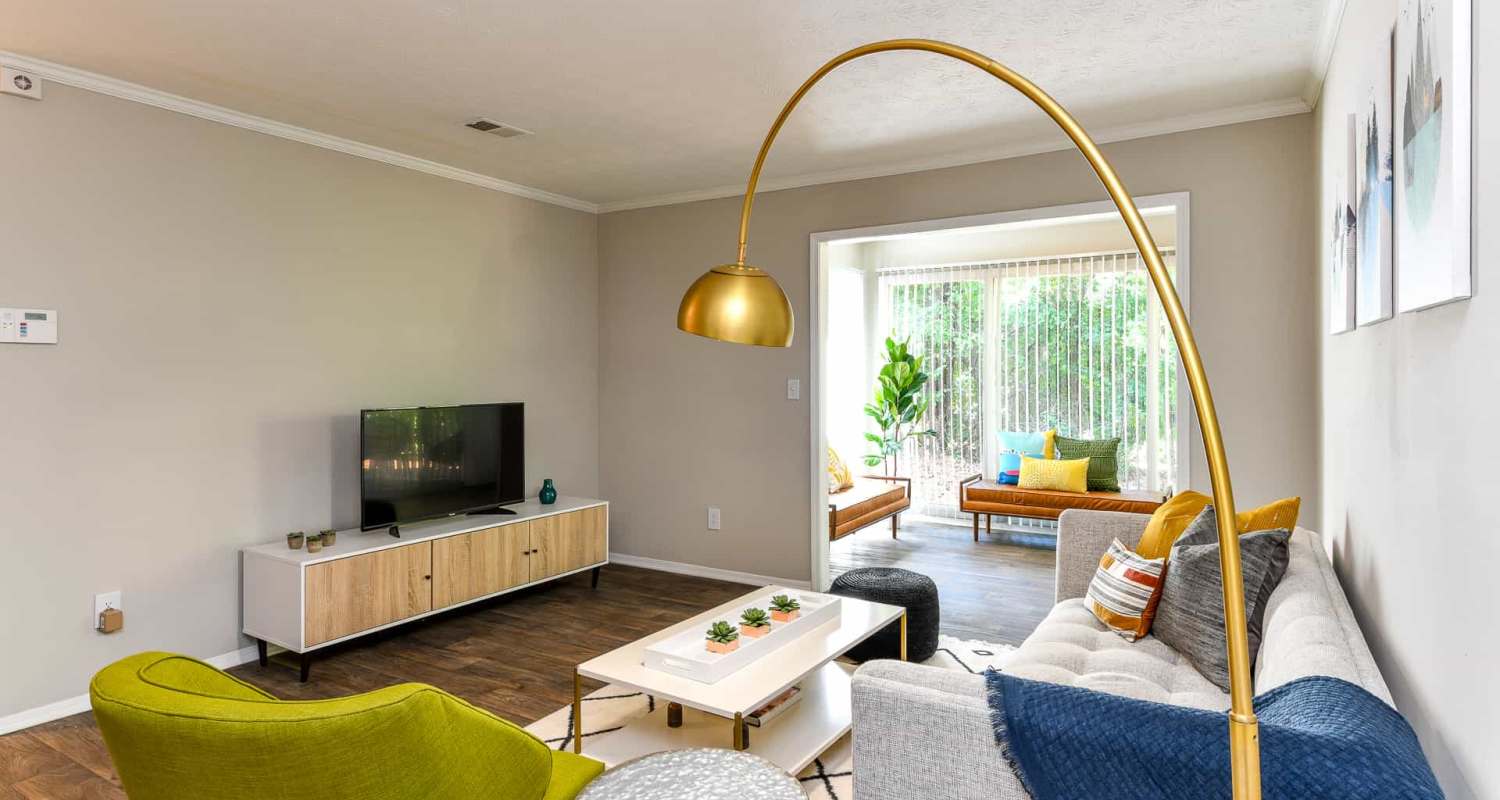 Spacious living room with large couch. chair, coffee table and flat screen television at Preserve At Dunwoody in Dunwoody, Georgia