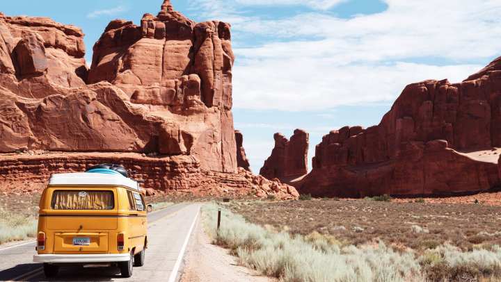 A passenger van driving through a national park