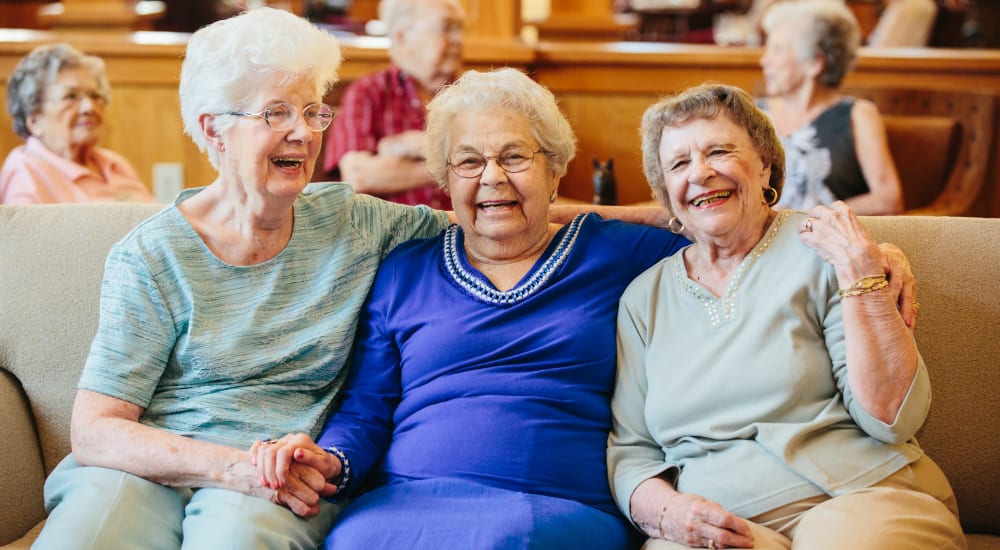 Three residents enjoying the comfortable lounge at The Springs at Missoula in Missoula, Montana