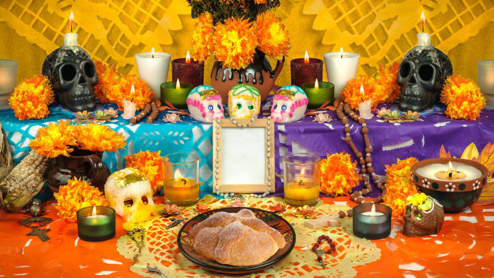 A Day of the Dead altar with sugar skulls and candles
