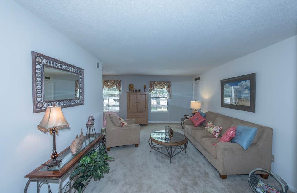 Living room with couch, carpet flooring, center table and windows at Pine Lakes in , South Carolina