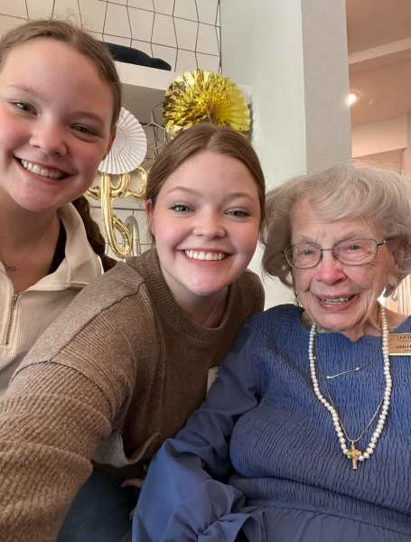 Grandchildren smiling with their grandmother at The Landing at Woodland Lakes in Conroe, Texas, sharing a happy family moment.