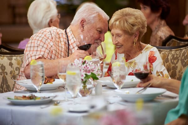 Resident couple share a special moment in the dining room at The Chamberlin in Hampton, Virginia