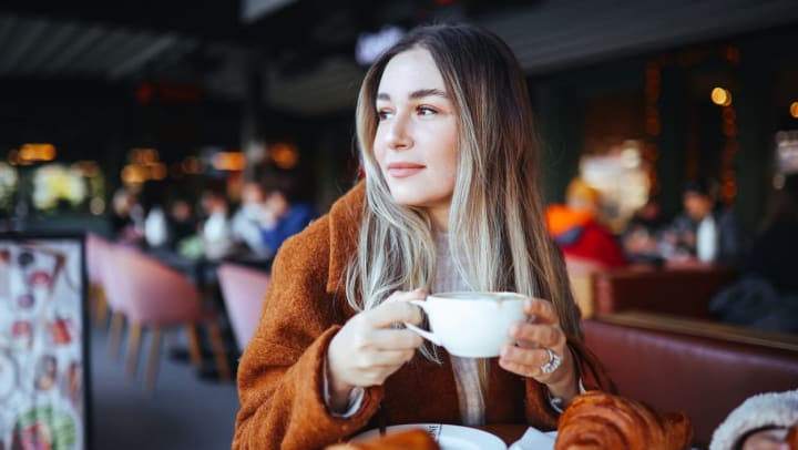shopper enjoying a croissant and a coffee | Katy Bakeries