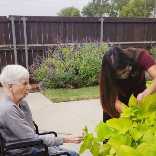 A happy resident outside of Oxford Glen Memory Care at Sachse in Sachse, Texas