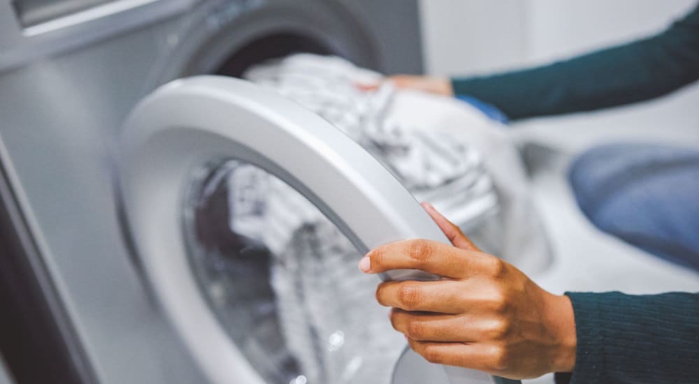 Resident doing laundry at Courtyard Apartments in Stockton, California