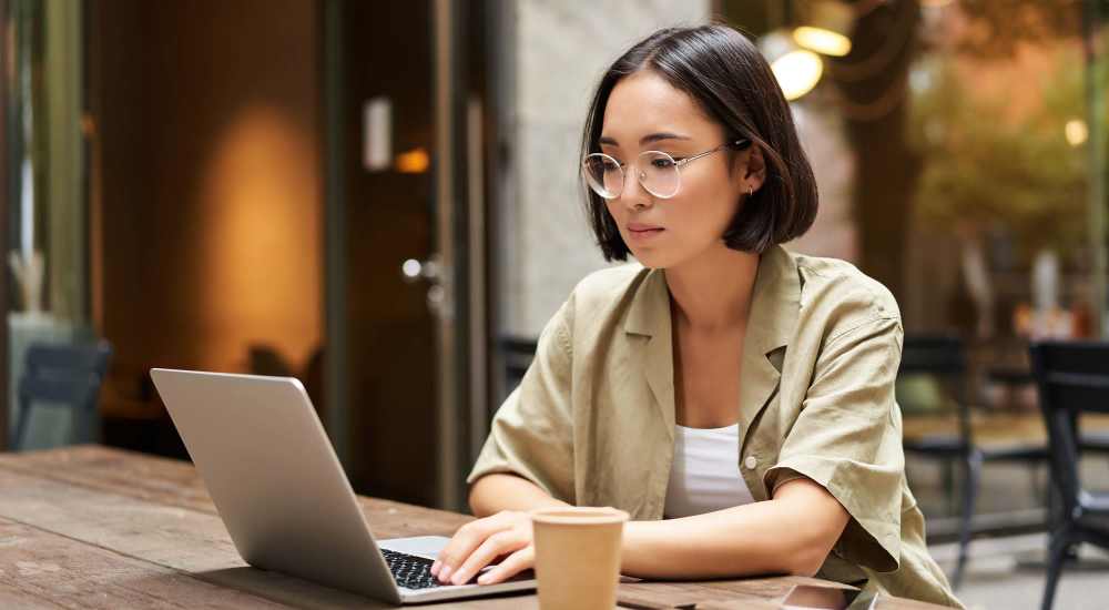 Resident working in the business center at Blue Bell Village One in Houston, Texas