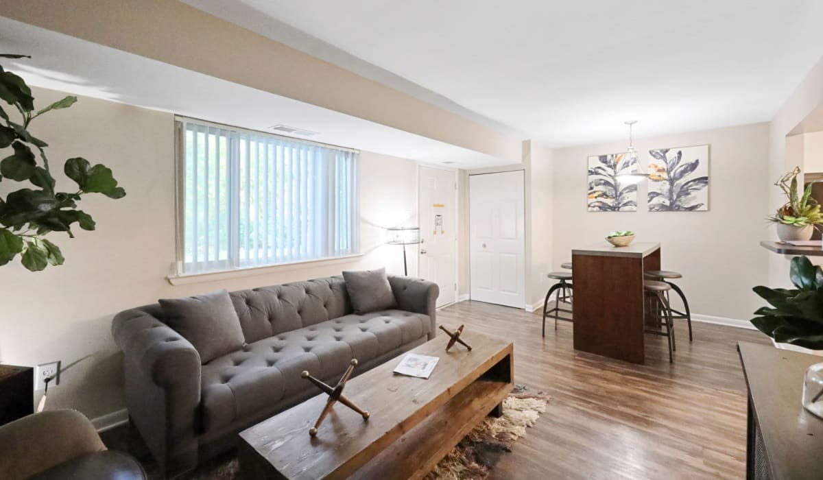 Living room with modern furnishings at The Seasons Apartments in Laurel, Maryland