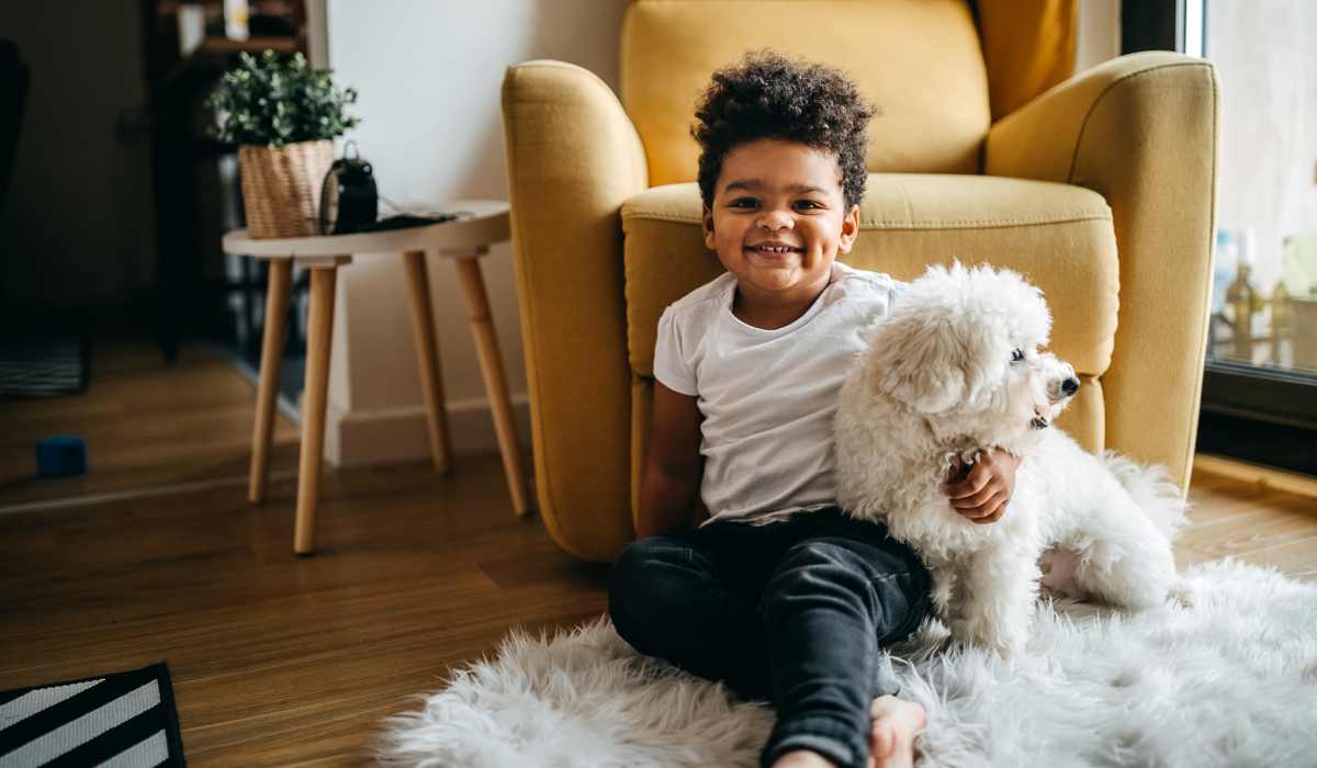 A kid with his pet in living room at Southwood Village in Shreveport, Louisiana