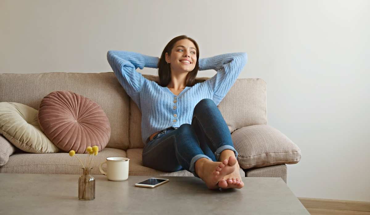 Resident relaxing in her living room at Village at First in Gilroy, California