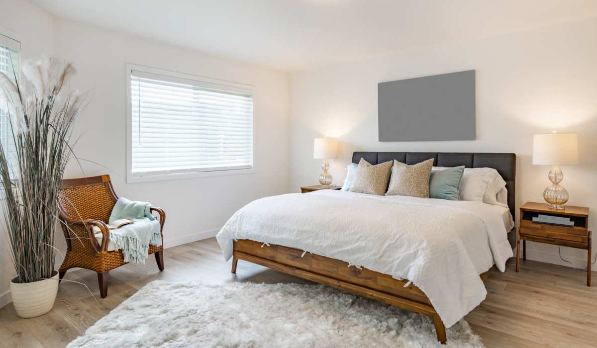 Bedroom with hardwood flooring and a comfortable bed at Parkway Commons in Moss Bluff, Louisiana
