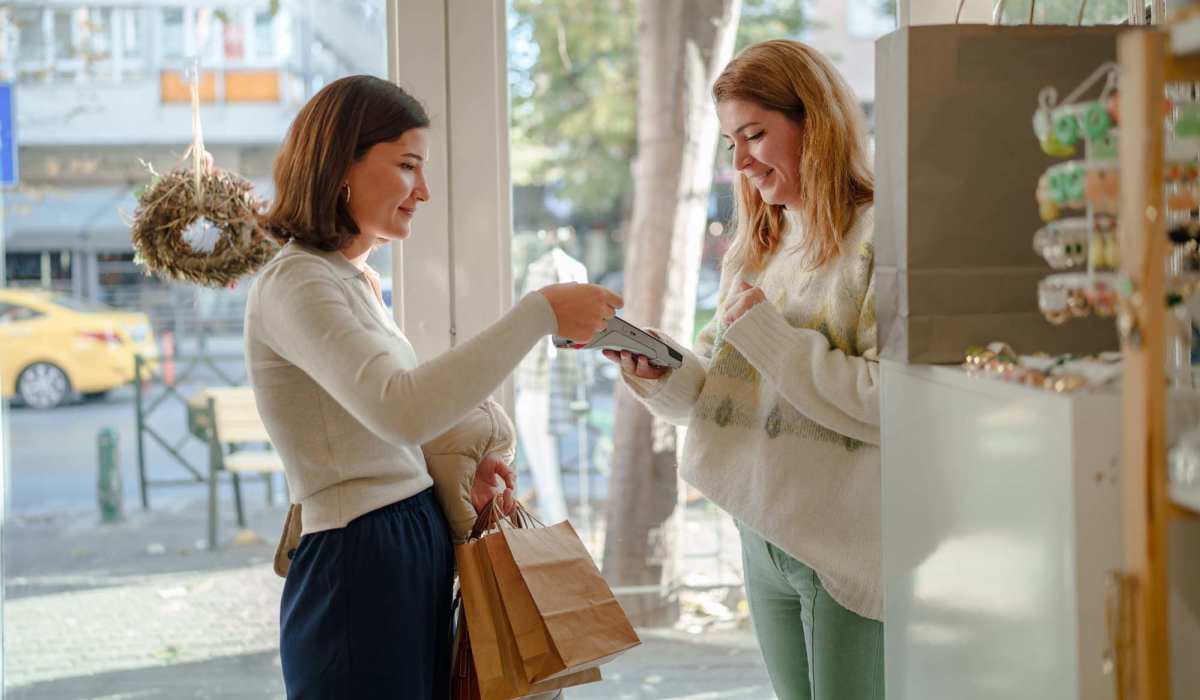Two women interacting inside a shop near Collins Crossing Apartments in Carrboro, North Carolina 