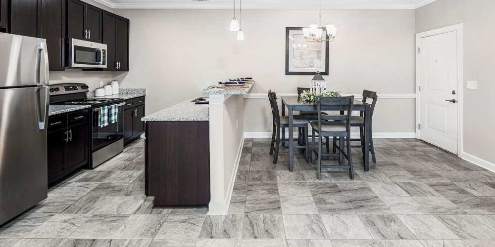 Fully-equipped kitchen with stainless-steel appliances and island countertop at Groves at Waters Edge in Waynesville, North Carolina 