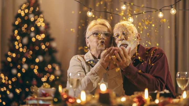 Old woman and man blowing glitters