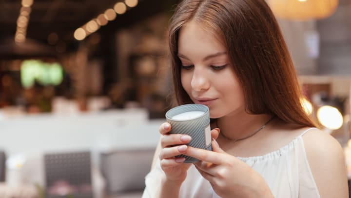 A woman smelling a candle | candle stores in Jacksonville