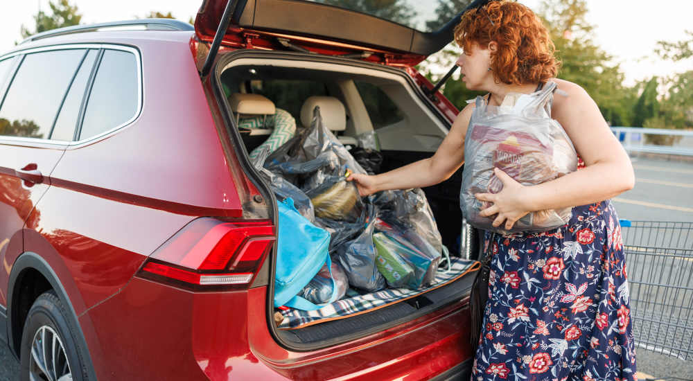 Woman unloading bags from car trunk at The Reid in Tucker, Georgia 