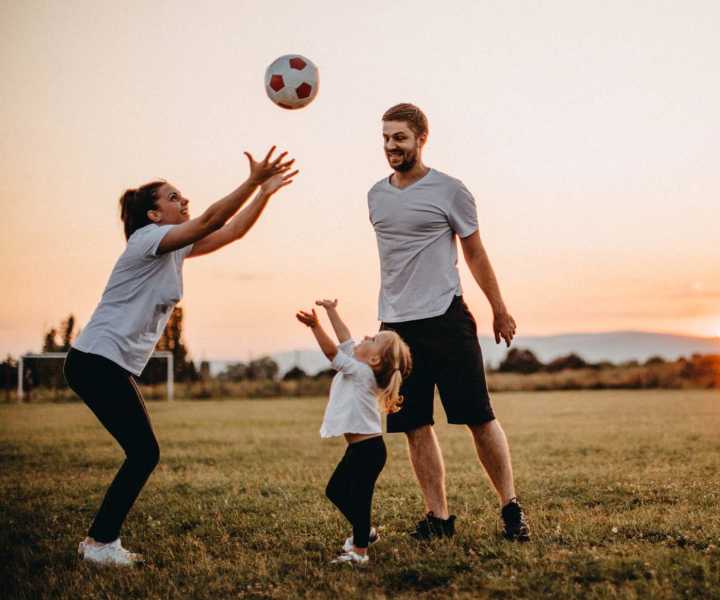 Resident with his kids playing at Lakewood Manor Apartments in Rochester, New York
