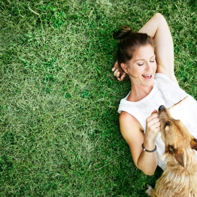 A resident relaxing in a yard with a dog at Marine Palms in Twentynine Palms, California