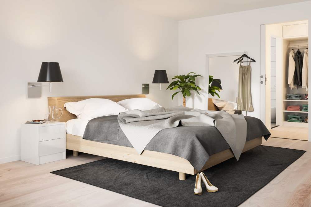 Modern bedroom with wood-style flooring and a spacious closet at Covered Bridge in Indianapolis, Indiana