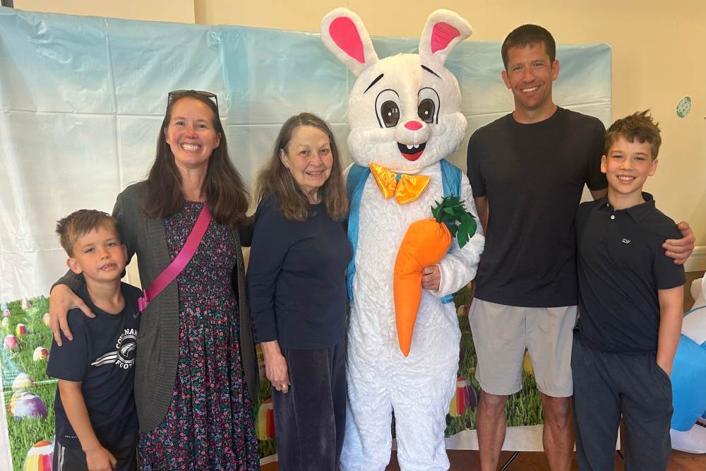 A family poses with an Easter Bunny mascot at The Barclay at Charlottesville in Charlottesville, Virginia.