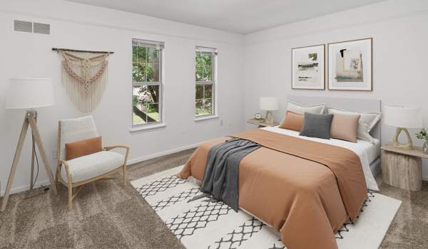 Cozy bedroom at Evergreen Park Townhomes and Apartments in Lansing, Michigan