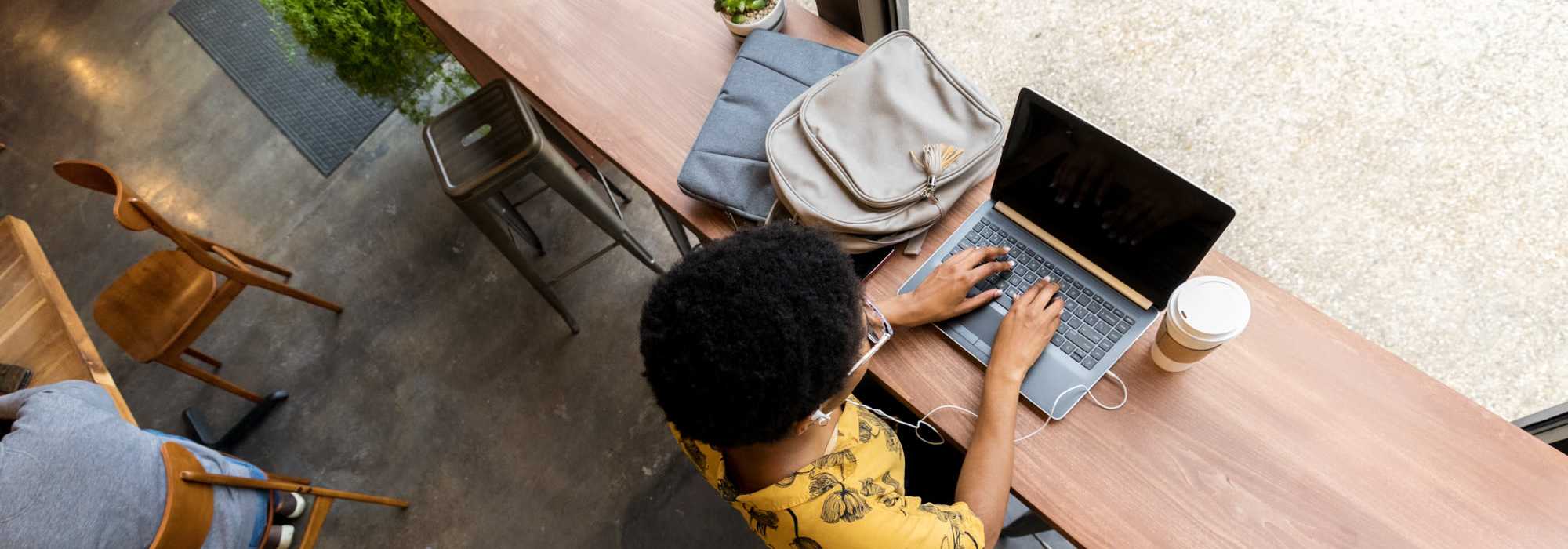 A woman doing her work in a laptop | Contact Us at Ventura Park Plaza Apartments in Portland, Oregon