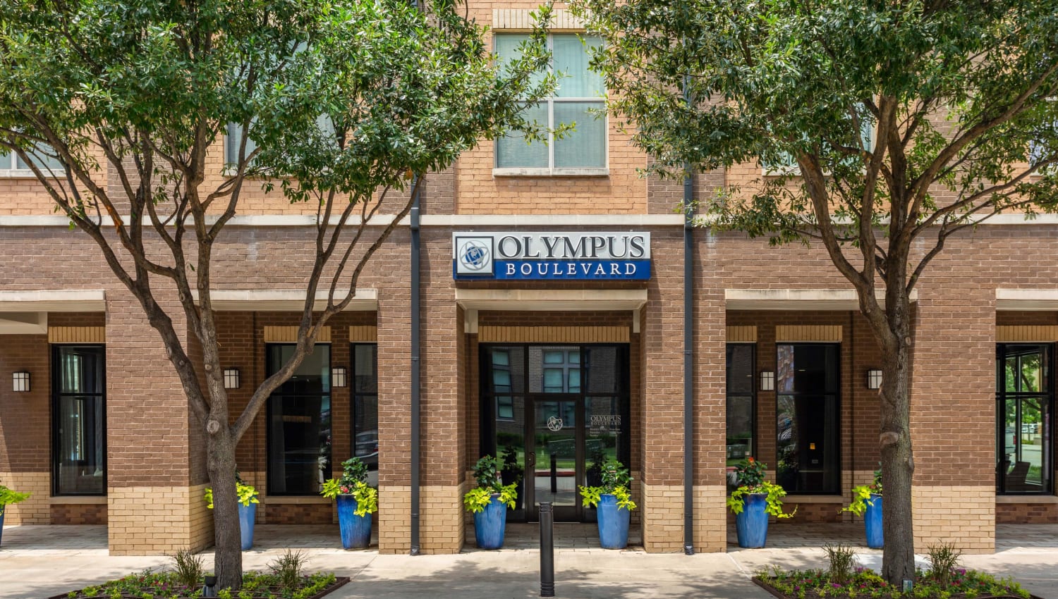 Leasing office outdoor shot of Olympus Boulevard in Frisco, Texas