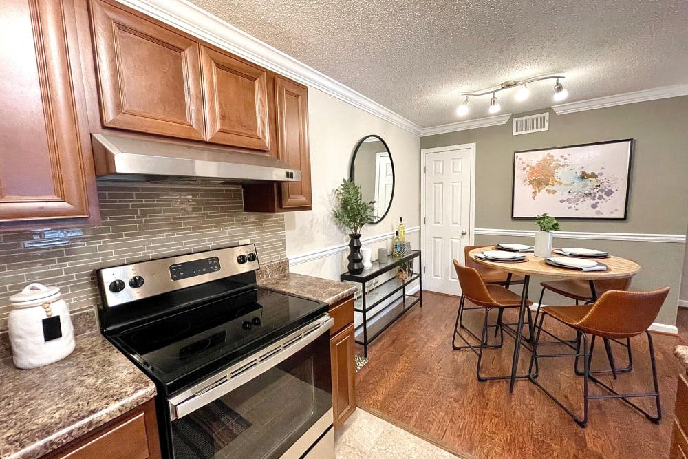 Kitchen and dining nook in an apartment at The Abbey at Riverchase in Hoover, Alabama