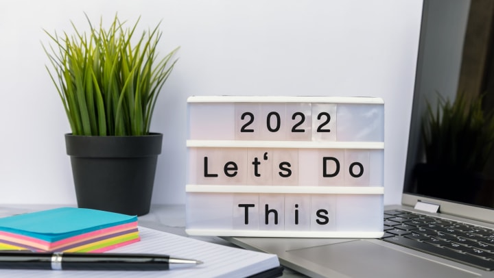 A letter board on a laptop that reads “2022 Let’s Do This.”