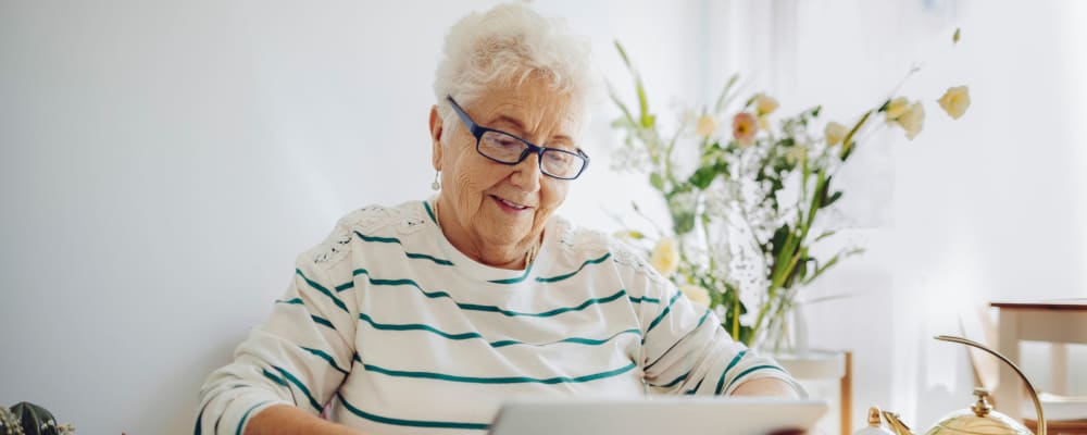A resident looking a at tablet at Peaks at Millcreek in Salt Lake City, Utah