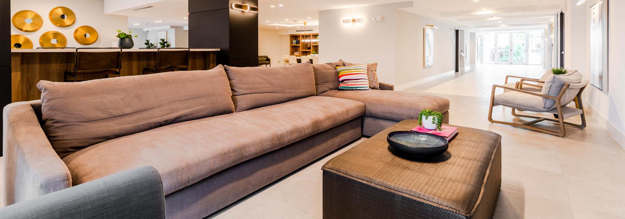 Community living room with large couch at Alture Westland in Hialeah, Florida