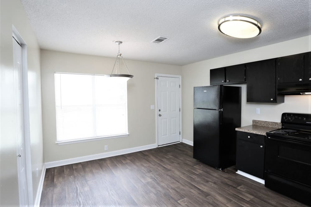 Large Kitchen in a 3 Bedroom Garden, some units have white and others black (shown) appliances at Madison Pines Apartment Homes in Madison AL