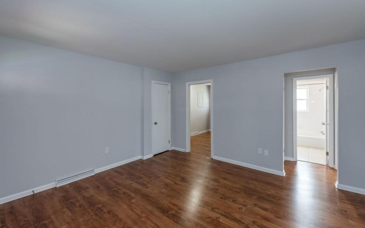 Bedroom with wood flooring at Signal Hill Apartments in Mechanicsville, Virginia