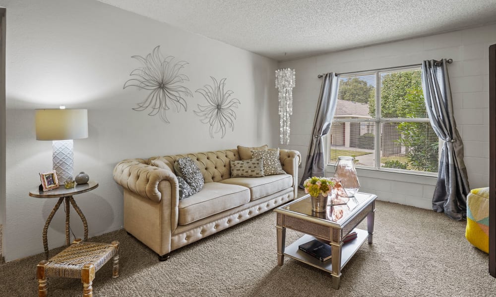 Spacious living room with plush carpeting at The Phoenix Apartments in El Paso, Texas