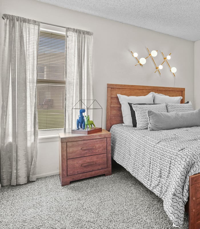 Carpeted bedroom at Aspen Park Apartments in Wichita, Kansas