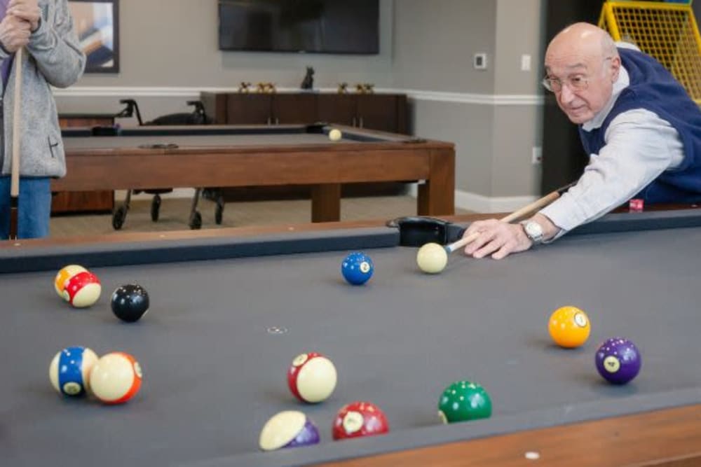 A resident playing pool at Crescent Fields at Huntingdon Valley in Huntingdon Valley, Pennsylvania