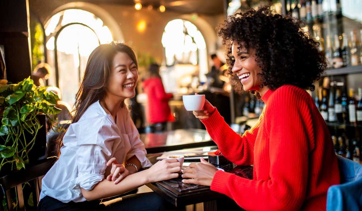 Friends having their favorite drinks at the cafe near The George Apartment Homes in Anaheim, California