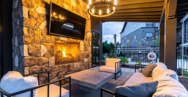 Outdoor lounge with a TV at The Holston | Apartments in Weaverville, North Carolina
