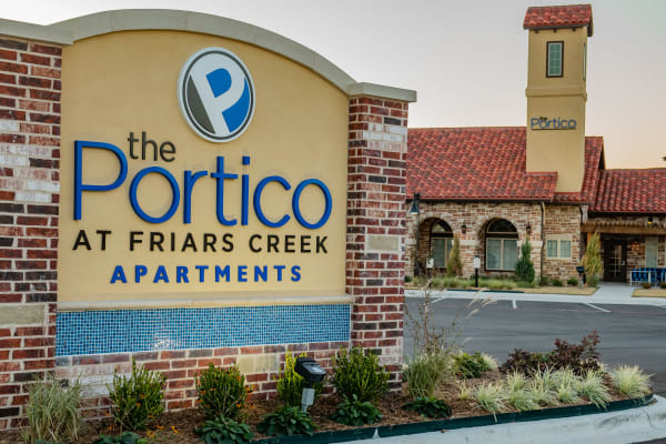Three girls walking in Portico at Friars Creek Apartments.
