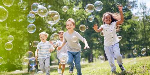 Kids running around and playing in the park near Douglas Park in Compton, California