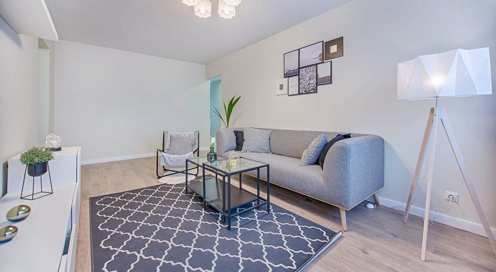 Spacious living with large couch, chair and coffee table at Monrovia Gardens in Monrovia, California 