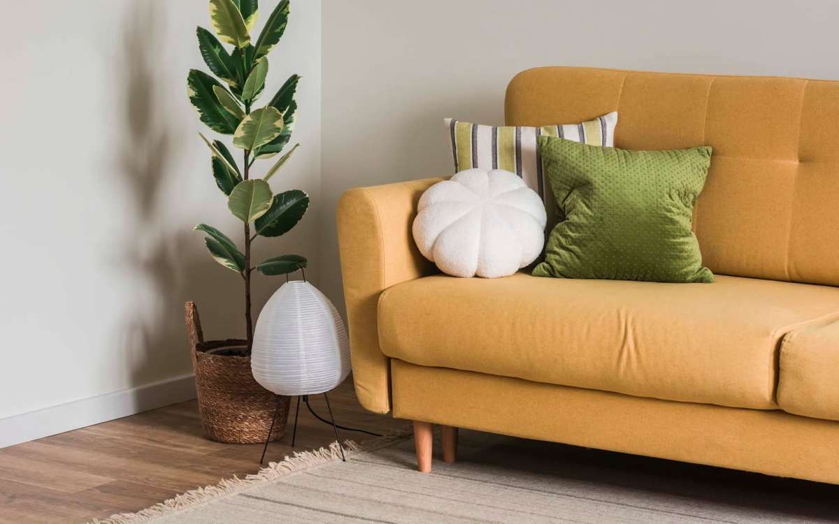 Living room with sofa and planter at Fox Hollow in Orlando, Florida