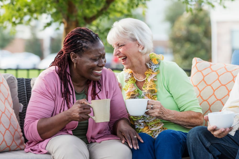 Residents enjoying coffee on the patio at Sunset Park Place in Dubuque, Iowa