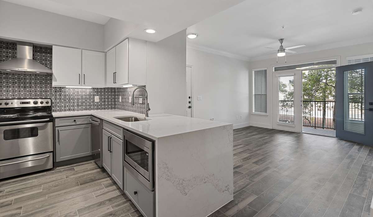 Spacious kitchen with white cabinetry at Kimpton in Houston, Texas