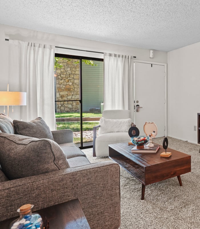 Spacious carpeted living room at Raintree Apartments in Wichita, Kansas