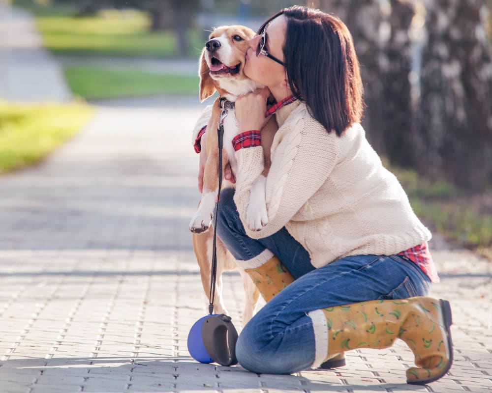  Resident and her dog stopping their walk for a kiss near Carrington Oaks in Buda, Texas