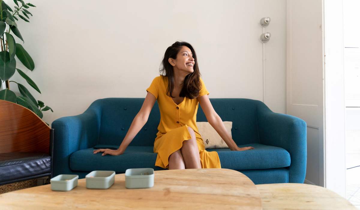 Resident relaxing in the living room of her new home at Mirada Apartments in Lewis Center, Ohio